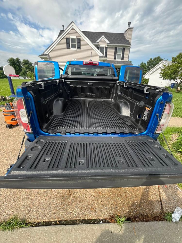 Clean detailed truck bed liner after mobile detailing, dust and debris removed